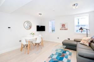 a living room with a couch and a table at Eldon Chambers Flat 1 by City Living London in London