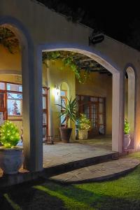 an entrance to a house at night with a potted plant at 17 on Bird Guest House in Beaufort West