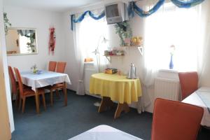 a dining room with a table and a yellow table cloth at Pension Janka Kdyně in Kdyně
