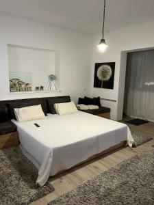 a bedroom with a large white bed in a room at Romantic apartments in Šibenik
