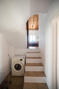 a laundry room with a washer and dryer and stairs at Villa Abella Paraga Mykonos, Traditional with amazing sea view, up to 6 people in Paradise Beach