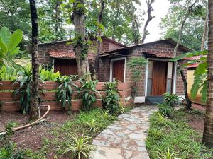 a brick house with a fire hose in front of it at Cheerful 2-Bedroom Villa with Private Plunge Pool, Candolim, Goa in Marmagao