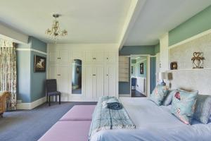 a bedroom with a large bed in a room at Equestrian Manor in Upton upon Severn