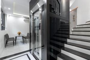a hallway with stairs and a table with chairs at Lakeside House 2 in Hanoi