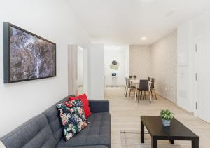 a living room with a couch and a table at Moderno apartamento urbano en barrio histórico 2ºI in Santa Cruz de Tenerife