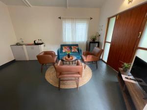 a living room with a couch and chairs and a table at Cheerful 2-Bedroom Villa with Private Plunge Pool, Candolim, Goa in Marmagao