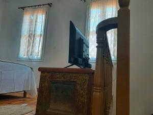 a television sitting on top of a fireplace in a living room at The Garden in Chios