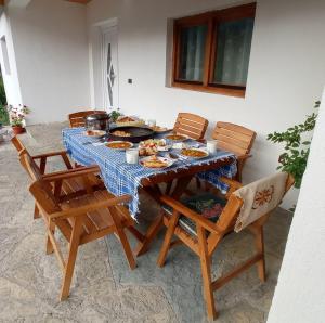 a table with plates of food on it at Bujtina Albjoni in Valbonë