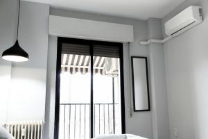 a bedroom with a large window and a bed at City Center in Granada