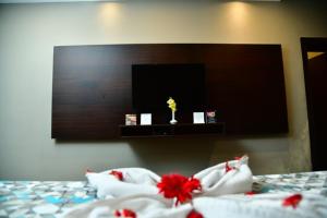 a bedroom with a bed with red flowers on it at The Presidency in Bhubaneshwar