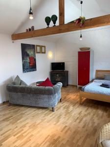 a living room with a couch and a table at Kleines Appartement in Sankt Augustin