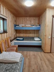 a room with two bunk beds in a cabin at Annimatsi Camping in Otepää