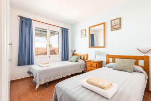 a bedroom with two beds and a window at Villa Iris Prima by Villa Plus in Punta Prima +28 photos