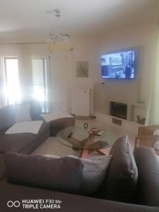 a living room with a couch and a table at Ducky House in Preveza