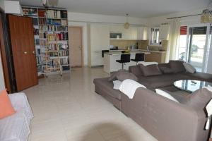 a living room with a couch and a kitchen at Ducky House in Preveza +6 photos