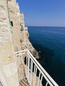 a view of the ocean from a balcony at Mareluna in Polignano a Mare