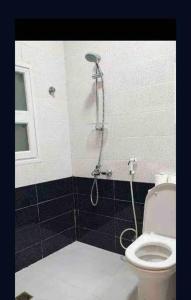a bathroom with a shower and a toilet at Beautiful Flat By The Beach Salalah in Salalah