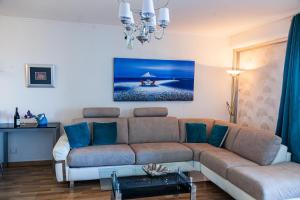 a living room with a couch and a table at Sea view luxury apartment in Saint-Laurent-du-Var