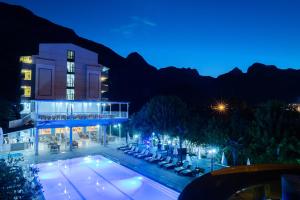 a resort with a swimming pool at night at Grand Hotel Derin-All Inclusive in Beldibi