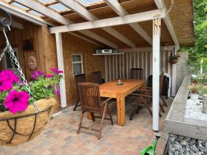 a wooden table and chairs on a patio at Haus Krönchen in Tanne