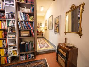 a hallway with book shelves filled with books at LUXURY - Elegante appartamento nel cuore di Lucca in Lucca