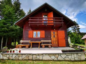 a log cabin with a porch and a balcony at Holiday Home Bella in Žabljak