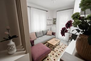 a living room with a couch and a table at Onar Village Luxury Apartments in Kavala