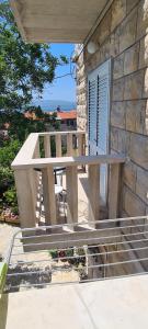 a stone house with a table and a bench at APARTMAN BRIGIT - CENTAR in Bol
