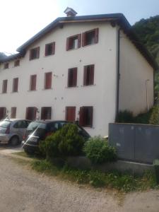 a white building with cars parked in front of it at Oltre il Poggio del Sole in Marostica