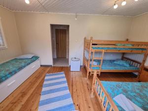 a room with two bunk beds and a hallway at Reiu Holiday Centre in Paikuse