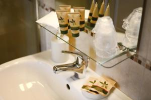 a bathroom sink with a faucet and a mirror at Agriturismo Poggio Degli Ulivi in Bomarzo