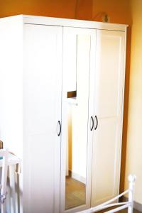 a white cabinet with a mirror in a room at Agriturismo Poggio Degli Ulivi in Bomarzo