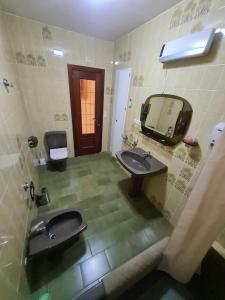 un bagno con due lavandini, uno specchio e un water di Casa Rural Los Pequeños (Monserrat) a Monserrat