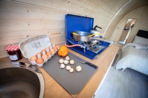 a kitchen with eggs on a cutting board next to a stove at West Point Woods in Barrow in Furness