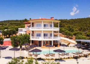 a large building with a swimming pool and umbrellas at Casa Bloo 360, Adults Only in Kalogria