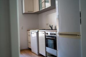 a kitchen with white cabinets and a stove top oven at Pension Ahnatal in Weimar