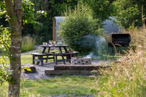 a picnic table and a grill in a yard at West Point Woods in Barrow in Furness