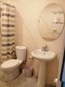 a bathroom with a toilet and a sink and a mirror at Na Na Twinhouse in Bang Tao Beach +15 photos