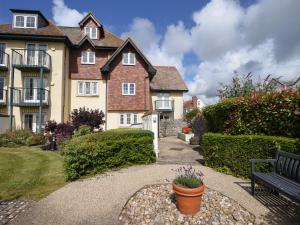 a house with a bench in front of it at 1 Buckfields in Lyme Regis +9 photos