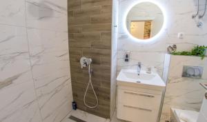 a bathroom with a shower and a sink and a mirror at Apartment Neretva Magic Dream in Mostar +23 photos