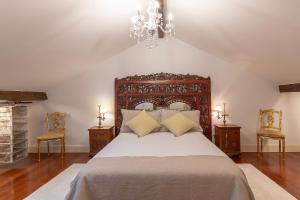 a bedroom with a large bed and two chairs at Vizcaya Bridge & Beach in Getxo