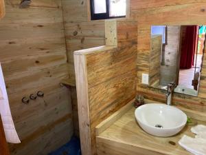 a bathroom with a sink and a mirror at Bungalows Baobab in San Isidro