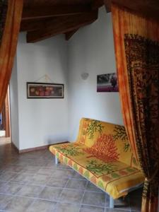 a room with a couch in the corner of a room at Residence Luna Rossa in Costa Rei