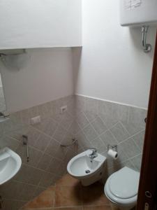 a bathroom with a toilet and a sink at Residence Luna Rossa in Costa Rei +58 photos