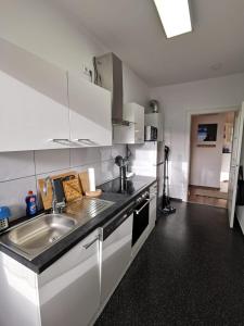 a kitchen with a sink and a counter top at Quirin in Neuss