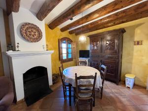 a dining room with a table and a fireplace at Nº7 in Aínsa