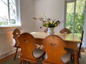 a table with chairs and a vase of flowers on it at Ferienhaus Leezen in Leezen +30 photos