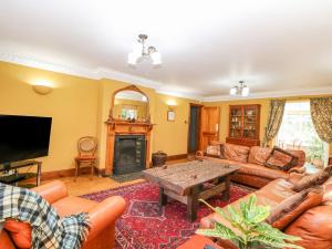 a living room with a couch and a table at The Firs in Wendling