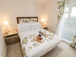 a bedroom with a bed with a tray of food on it at Rockpool Retreat in Saltburn-by-the-Sea