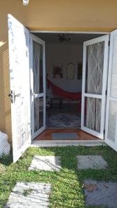 an open door of a house with a porch at Acomodação central e WI-FI in São Lourenço do Sul